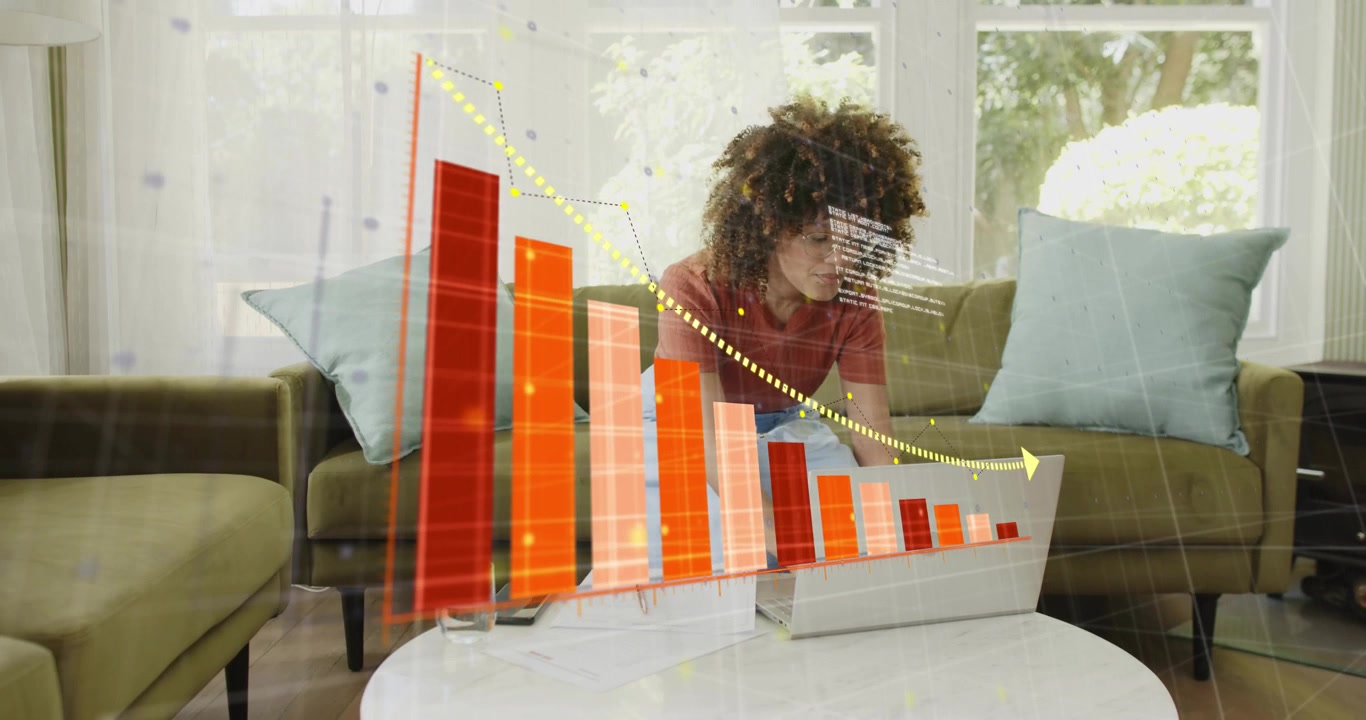 Mid-adult woman placing smartphone, opening laptop, initiating 3D finance bars with downward trend