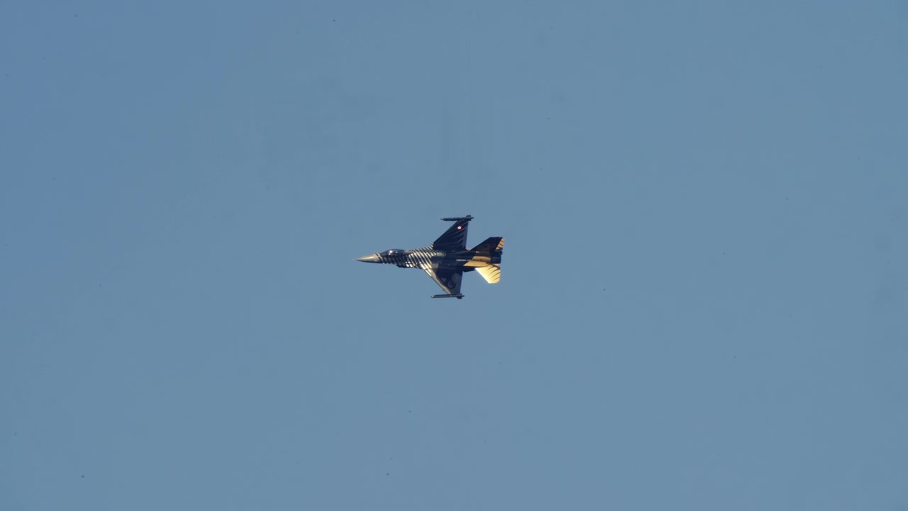 Modern Fighter Jet Flying Across a Clear Blue Sky