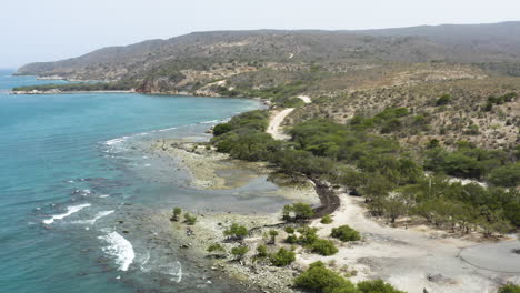 AERIAL---Beautiful-Monte-Rio-beach,-Azua,-Dominican-Republic,-lowering-shot