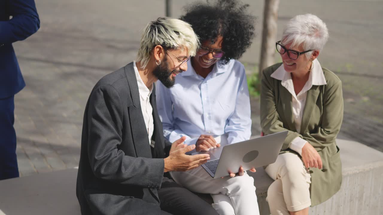 Diverse business team collaborating on a laptop