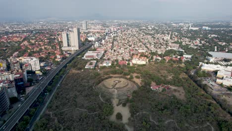 backwards-drone-shot-of-Cuicuilco-pyramid-at-south-mexico-city