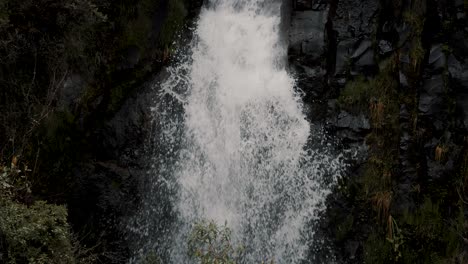 water cascading down on rocks in a mountain forest - cayambe coca national park in papallacta, ecuador - slow motion