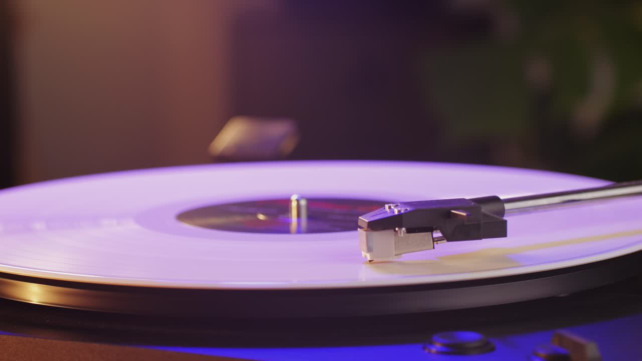 Retro Vinyl record player playing music, close-up macro shot of vintage LP disc old phonograph spinning. Retro music player.
