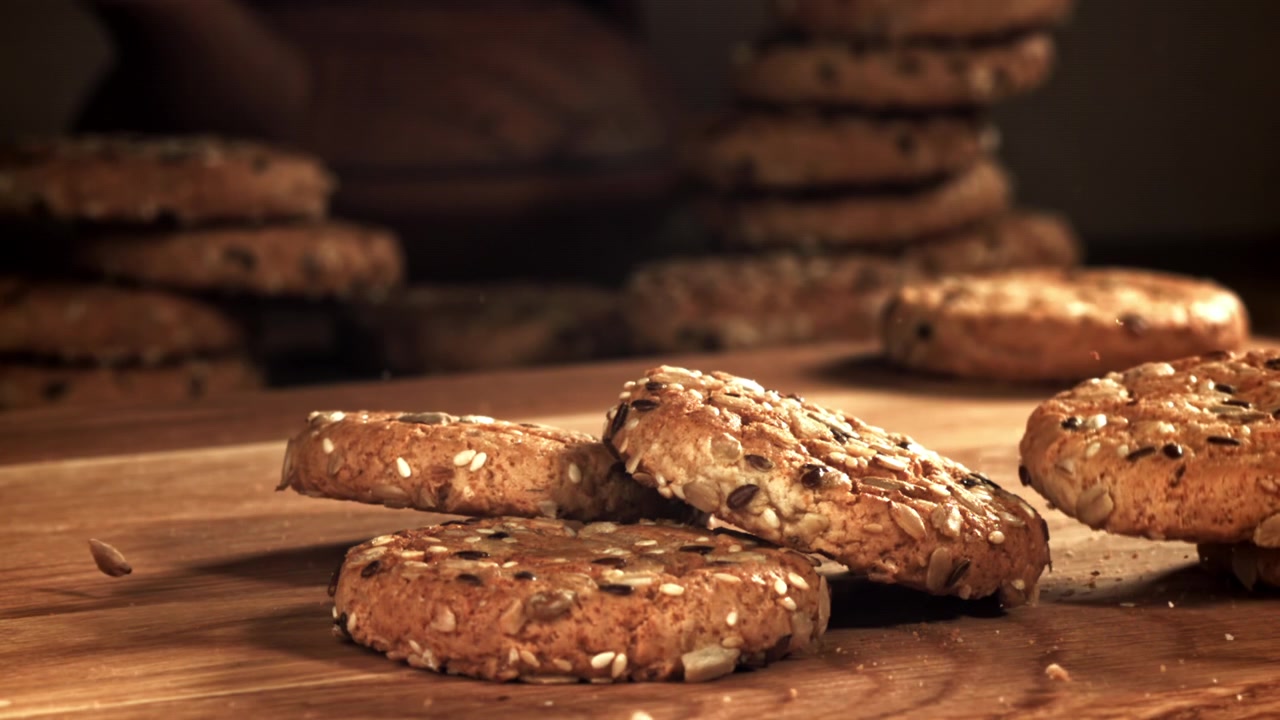 Slow Motion of Healthy Seed Cookies Falling on a Wooden Table