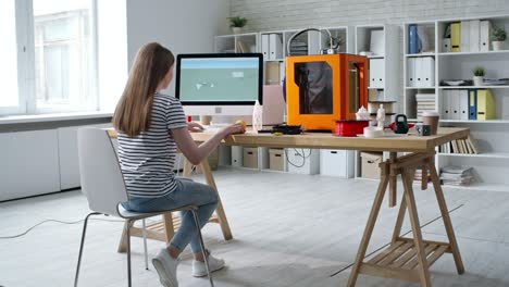 female designer creating 3d model on computer