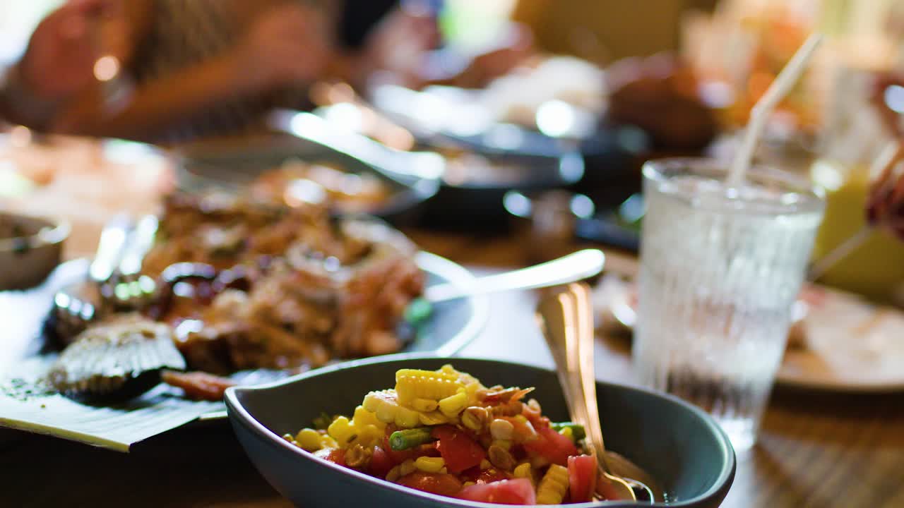 Close-up of som tam corn salad on wooden table, natural daylight, shallow focus, casual dining