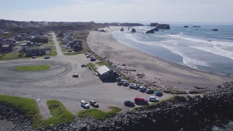 slow aerial pan across iconic pacific northwest beach as waves crash on sand