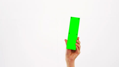 hand of a woman holding green pla card