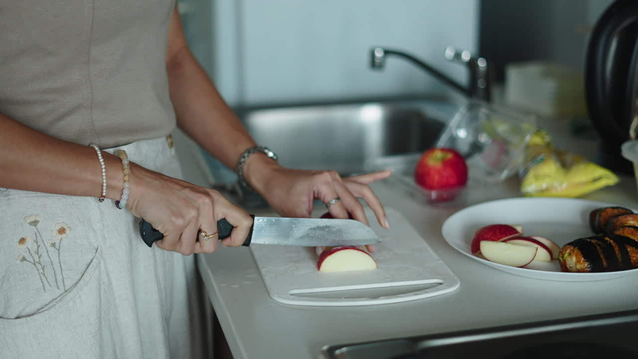 Woman Cutting Apples in the Kitchen