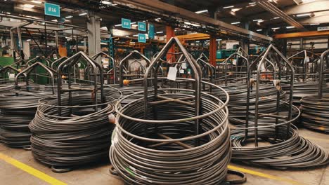 a close-up view of coiled metal cables organized neatly in an industrial warehouse.