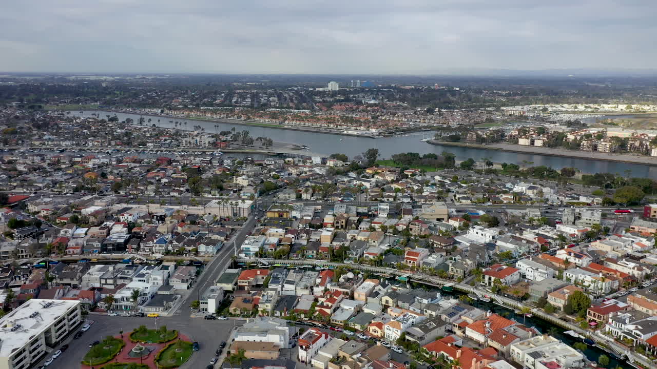 Long Beach California, USA. Beautiful aerial shot of houses, trees, blue water and the city. Panning establishing shot of the area.