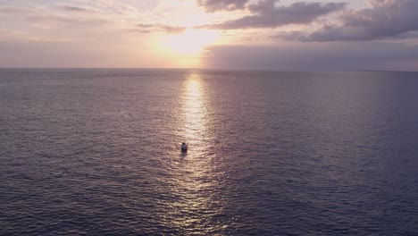 wide shot of fishing boat on calm ocean near mallorca, aerial