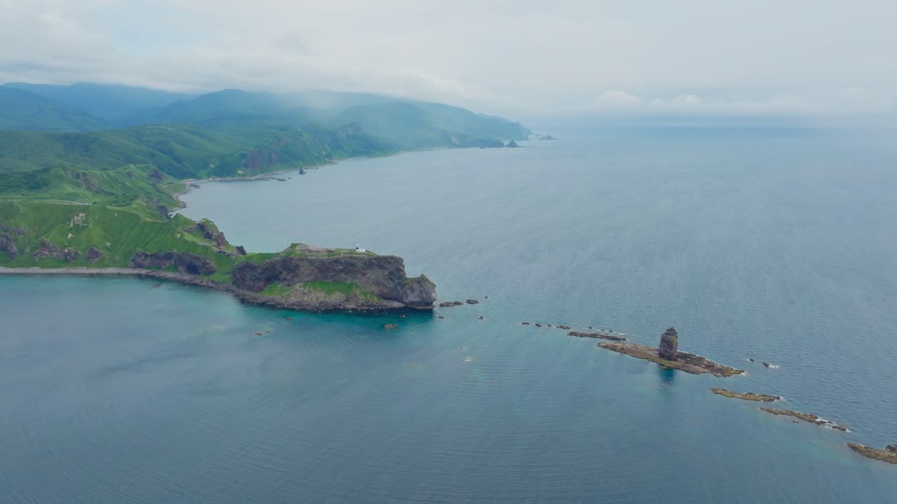 Aerial establishing reveals Japanese hidden sea landscape in Shakotan Hokkaido, beach cliff cape, headlands and famous stone islands