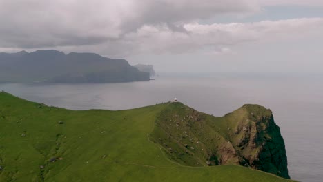 distant view of kallur lighthouse in kalsoy, faroe islands, denmark