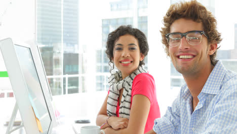 Young-colleagues-working-together-on-computer-