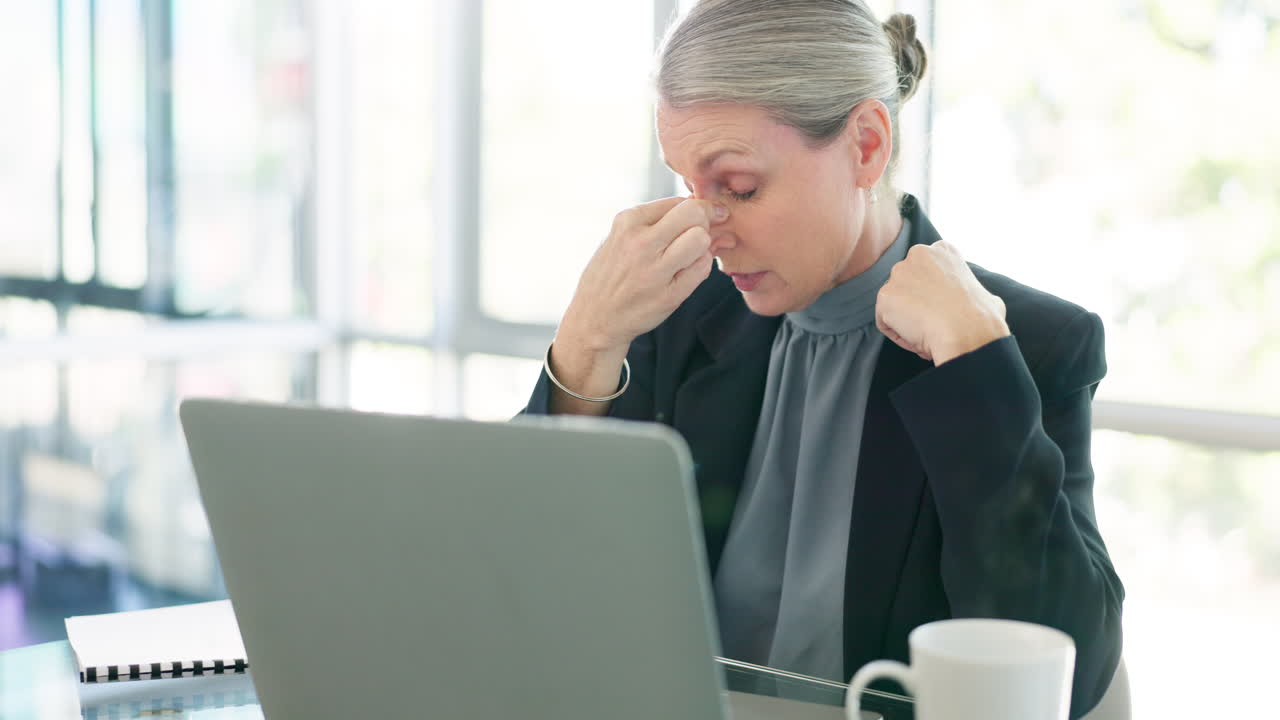 Laptop, stress or headache for mature woman