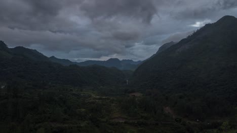 drone aerial hyperlapse during sunset of a beautiful landscape view with mountains, cloud weather and a river in guatemala, central america