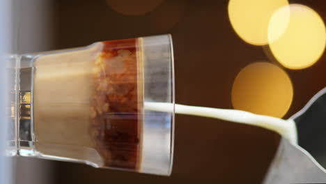 4K-VERTICAL,-Milk-Pours-in-Clear-Glass-with-Brewed-Espresso-Coffee,-Slowmo-Loop