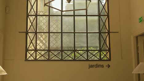 revealing shot of a large glass window looking out onto the private garden