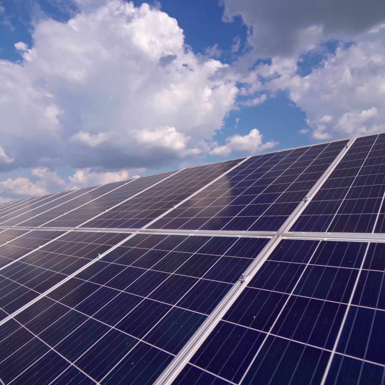 Blue solar panel close-up. Alternative source of electricity on solar energy farm. Source of ecological renewable energy. Motion camera back.
