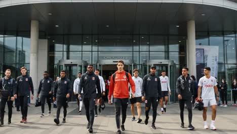 team walkout: athletes in uniform departing the training facility in a coordinated and confident manner, setting the stage for upcoming challenges and competition