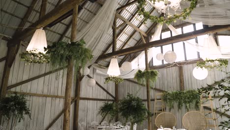 boho vintage wedding hall with stunning white lighters and green plants