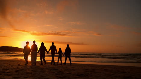 sunset, walking and shadow of family at the beach