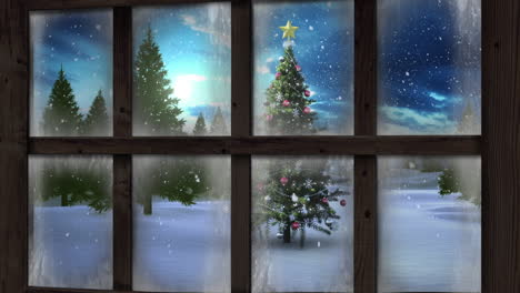 Wooden window frame against snow falling over christmas tree on winter landscape