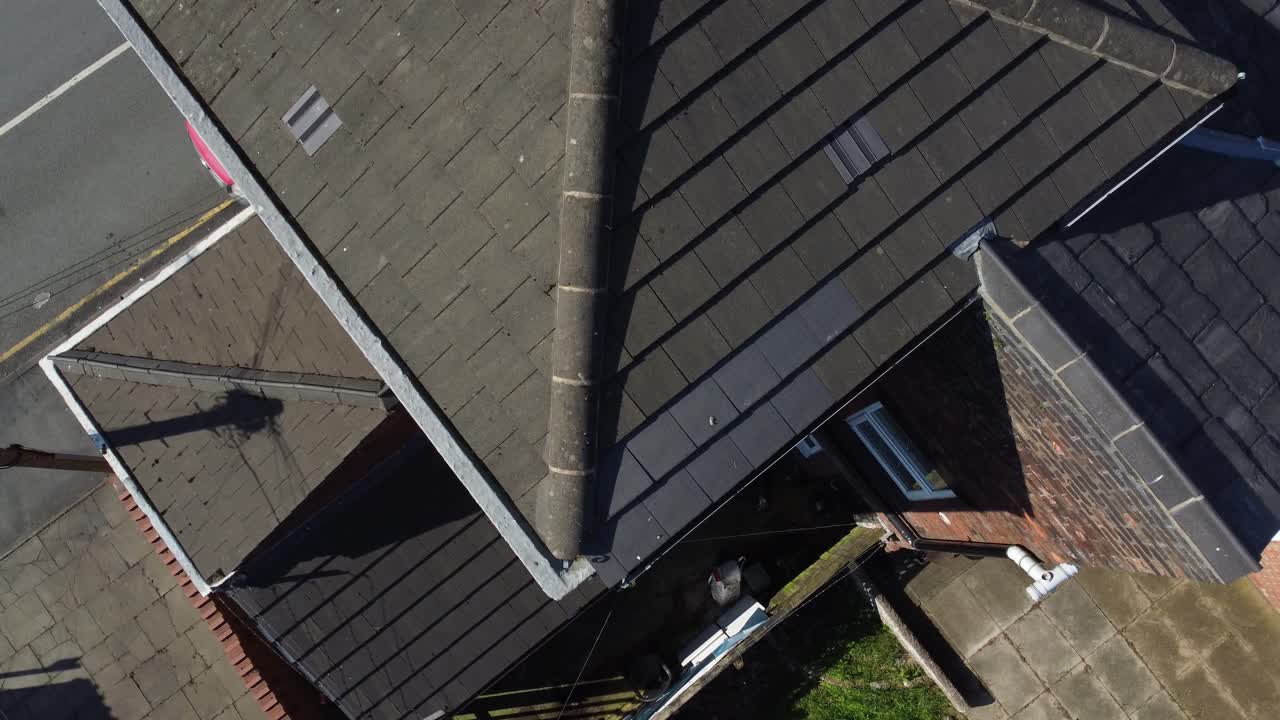 Rooftop inspection aerial view inspecting damage and repair of housing for homeowner