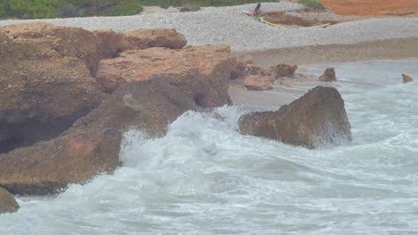 Slow-motion-cinematic-shot-of-a-wave-crashing-on-rock-coast