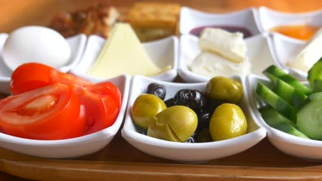 a turkish breakfast spread on a wooden tray