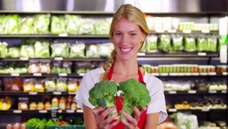 female staff checking vegetables in organic section