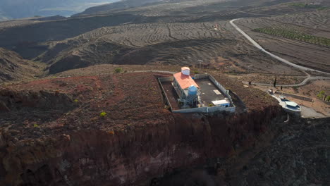 aerial view traveling out over the temisas astronomical observatory and the mountain where it is, in the municipality of aguimes