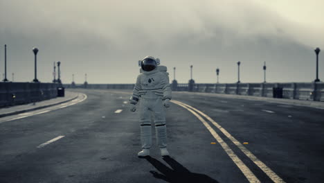 astronaut walks in the middle of a road