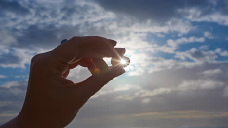 holding a seashell and watching the sunset