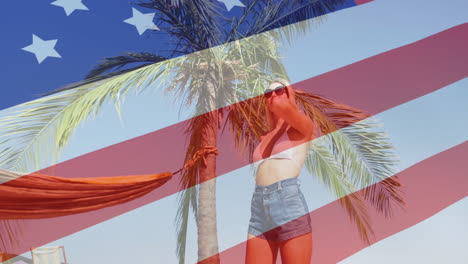 american flag animation over woman in sunglasses standing near palm tree