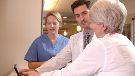 medical team meet at nurses station in hospital shot on r3d