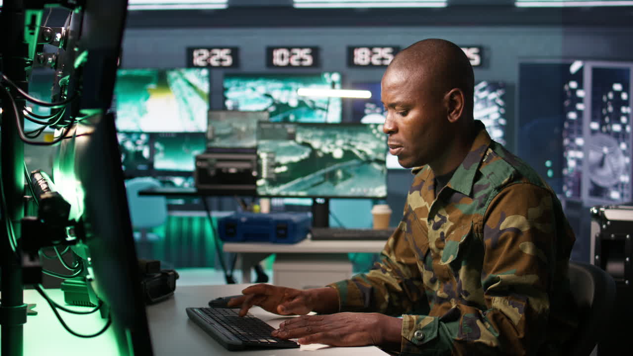 Portrait of military agent working in control room, analyzing aerial data