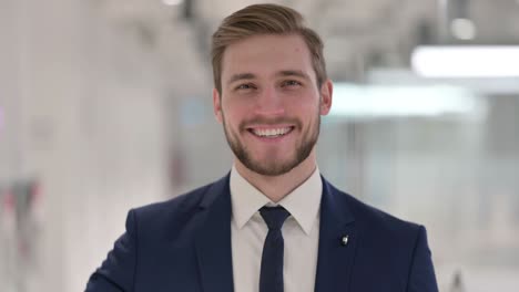 young businessman showing thumbs up sign