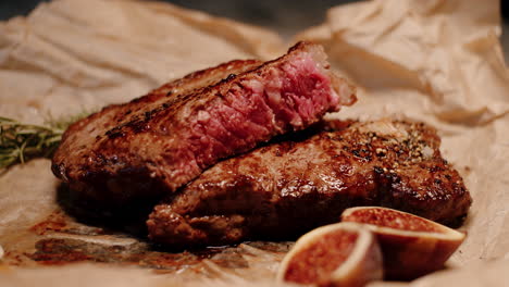 juicy caramelized steak cut in half cooked medium rare, rustic presentation