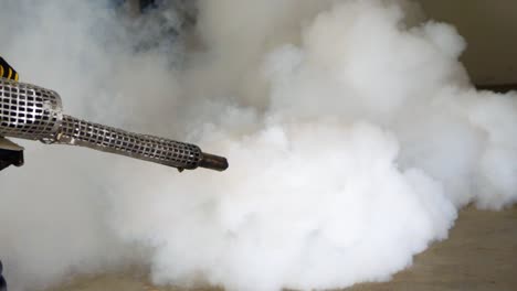 Slow-motion-of-fogging-service,-pest-control-with-mosquito-repellent