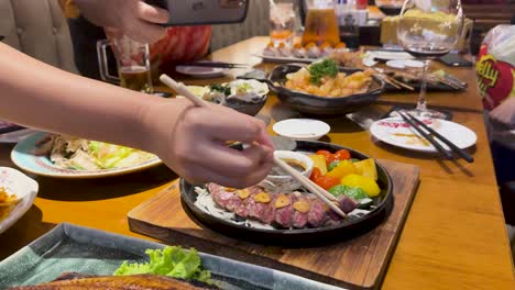 enjoying a meal with sizzling beef and friends