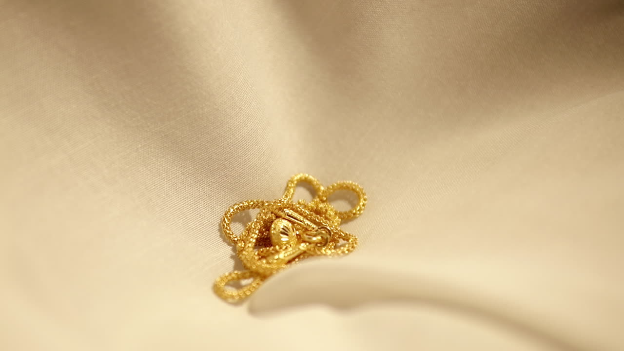 Gold Wedding Necklace dropped on a velvet cloth. Jewelry for Weddings and engagements.