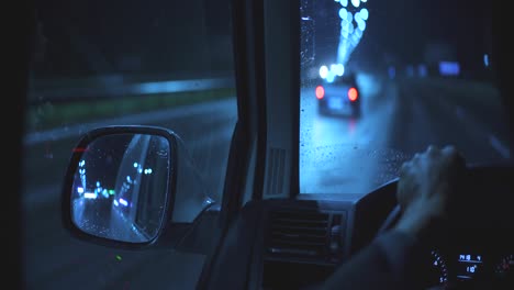 the man driving the car on the night highway