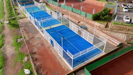 aerial static view of people playing paddle in outdoors padel curt