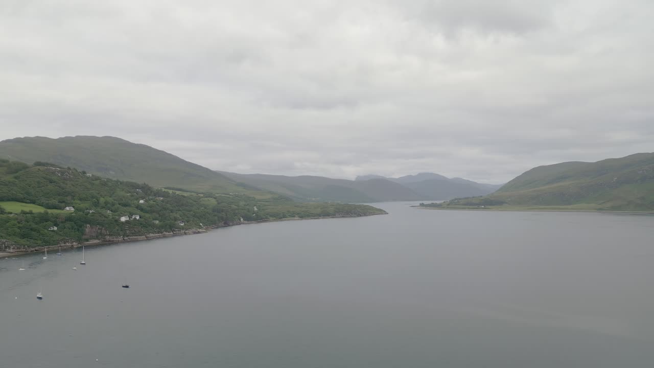 Scenic view of a bay with mountains and sailboats