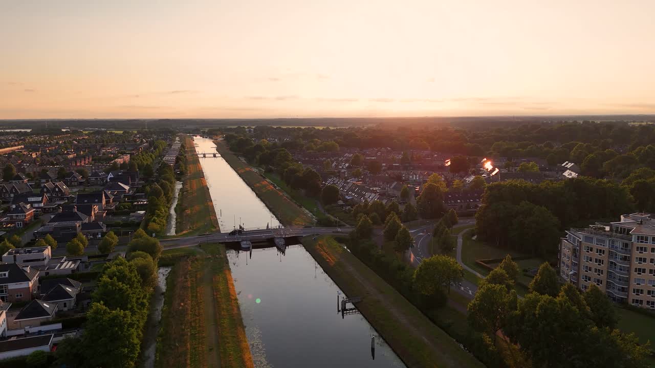 Aerial View of a Canal and Residential Area at Golden Hour