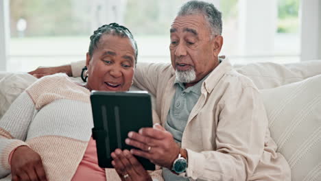 Happy,-interracial-couple-and-a-tablet-on-the-sofa