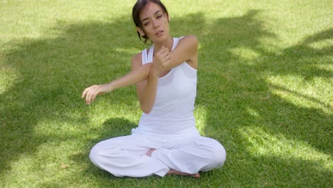 Pretty-single-woman-in-empty-yard-stretching-arms