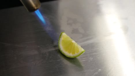 caramelizing a lime slice with a torch